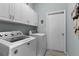 Laundry room with washer, dryer, and ample cabinet storage at 6019 Live Oak Dr, Winter Haven, FL 33880