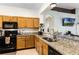 Kitchen with granite countertops, stainless steel appliances, and oak cabinets at 6019 Live Oak Dr, Winter Haven, FL 33880