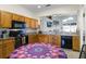 Kitchen boasting granite counters, wood cabinets, and a round dining table at 6019 Live Oak Dr, Winter Haven, FL 33880