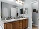 Double vanity bathroom with granite countertop and large mirror at 6019 Live Oak Dr, Winter Haven, FL 33880