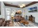 Open living room with leather sofas, a view of the kitchen, and a mounted TV at 6019 Live Oak Dr, Winter Haven, FL 33880