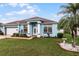 Cute light blue house with a two-car garage and manicured lawn at 6019 Live Oak Dr, Winter Haven, FL 33880