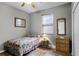 Bedroom with double bed, wicker dresser, and window with blinds at 6019 Live Oak Dr, Winter Haven, FL 33880