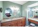 Double vanity bathroom with granite countertops and large mirrors at 653 Pelican Bay Dr, Daytona Beach, FL 32119