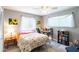 Bedroom with a floral bedspread, desk, and bookshelf at 653 Pelican Bay Dr, Daytona Beach, FL 32119
