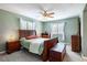 Bedroom with wooden sleigh bed, ample closet space, and dresser at 653 Pelican Bay Dr, Daytona Beach, FL 32119