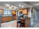 Kitchen with light wood cabinets, granite countertops, and breakfast bar at 653 Pelican Bay Dr, Daytona Beach, FL 32119