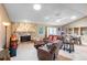 Spacious living room with stone fireplace and adjacent dining area at 653 Pelican Bay Dr, Daytona Beach, FL 32119