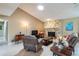 Living room with a stone fireplace, comfortable seating, and a large TV at 653 Pelican Bay Dr, Daytona Beach, FL 32119
