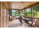 Relaxing screened porch with seating and ceiling fan at 653 Pelican Bay Dr, Daytona Beach, FL 32119
