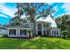 Two-story house with gray siding, dark windows, and a lush green lawn at 6893 Hidden Glade Pl, Sanford, FL 32771