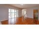 Dining area with hardwood floors, sliding glass doors, and kitchen access at 6893 Hidden Glade Pl, Sanford, FL 32771