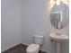 Clean and updated bathroom with pedestal sink and oval mirror at 6893 Hidden Glade Pl, Sanford, FL 32771