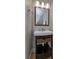 Well-appointed bathroom with a pedestal sink, mirror, and wicker basket at 6893 Hidden Glade Pl, Sanford, FL 32771