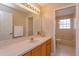 Bathroom with single vanity and adjacent toilet and tub at 6893 Hidden Glade Pl, Sanford, FL 32771
