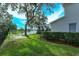 Landscaped backyard with lake view and patio seating at 6893 Hidden Glade Pl, Sanford, FL 32771