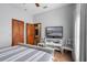 Bedroom with TV, striped bedding and adjacent bathroom access at 1562 Anorada Blvd, Kissimmee, FL 34744