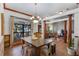 Bright dining room with a rustic farmhouse table and chandelier at 1562 Anorada Blvd, Kissimmee, FL 34744