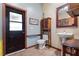 Bathroom with pedestal sink, toilet, grab bar, and exterior access at 1562 Anorada Blvd, Kissimmee, FL 34744