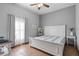 Bedroom with white bed frame, striped bedding, and window curtains at 1562 Anorada Blvd, Kissimmee, FL 34744
