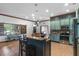 Stylish kitchen with light teal cabinets and stainless steel appliances at 1562 Anorada Blvd, Kissimmee, FL 34744