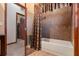 Main bathroom with tiled shower/tub, and access to a walk-in closet at 1562 Anorada Blvd, Kissimmee, FL 34744