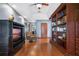 Library with built-in shelving, hardwood floors and a comfortable armchair at 1562 Anorada Blvd, Kissimmee, FL 34744