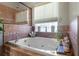 Bathroom with a large soaking tub and tiled floors at 1562 Anorada Blvd, Kissimmee, FL 34744