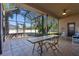 Spacious screened patio with wooden table and chairs, perfect for outdoor dining at 1562 Anorada Blvd, Kissimmee, FL 34744