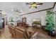 Relaxing living room with leather furniture, ceiling fans, and tile flooring at 1562 Anorada Blvd, Kissimmee, FL 34744