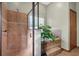 Spa-like bathroom with walk-in shower, soaking tub, and tiled floors at 1562 Anorada Blvd, Kissimmee, FL 34744