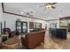 Open living room and kitchen with leather sofas and barn door separating the rooms at 1562 Anorada Blvd, Kissimmee, FL 34744