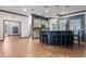 Island kitchen with breakfast bar, tile flooring, and access to adjacent living areas at 1562 Anorada Blvd, Kissimmee, FL 34744