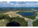 Aerial view of community near a lake, showcasing new homes at 16862 Muskgrass Dr, Winter Garden, FL 34787