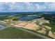 Aerial view of community with lake, homes and new construction at 16862 Muskgrass Dr, Winter Garden, FL 34787