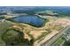 Aerial view of community and lake with surrounding landscape at 16862 Muskgrass Dr, Winter Garden, FL 34787
