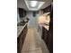 Galley kitchen with dark cabinets and white appliances at 2546 Lemon Tree Ln # 4, Orlando, FL 32839