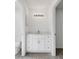 Clean bathroom with white vanity, quartz countertop, and a large mirror at 2670 Bentley Dr, Deltona, FL 32738
