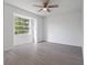 Bright bedroom with wood-look floors and a large window at 2670 Bentley Dr, Deltona, FL 32738