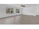 Large bedroom with wood-look flooring and two large windows at 3211 Eagle Watch Dr, Kissimmee, FL 34746