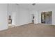 Living area with carpet flooring, access to bathroom and sliding doors to patio at 3211 Eagle Watch Dr, Kissimmee, FL 34746
