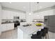 Kitchen with white cabinets, granite countertops, and stainless steel appliances at 9150 Harris Hawk Dr, Leesburg, FL 34788