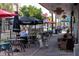 Outdoor patio seating at a restaurant with umbrellas at 9150 Harris Hawk Dr, Leesburg, FL 34788