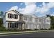 Modern two-story townhome with gray siding and green door at 9332 Bolshoi Aly, Winter Garden, FL 34787