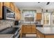 Bright kitchen featuring wood cabinets, stainless steel appliances, and ample counter space at 1161 Cathcart Cir, Sanford, FL 32771