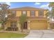 Two-story house with yellow exterior and brown roof at 1161 Cathcart Cir, Sanford, FL 32771