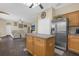 Open kitchen with stainless steel appliances and an island overlooking the living room at 1161 Cathcart Cir, Sanford, FL 32771