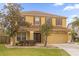 Two-story house with yellow exterior and brown roof at 1161 Cathcart Cir, Sanford, FL 32771