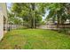 Large grassy backyard with wooden privacy fence at 12105 Harkness Ct, Orlando, FL 32828