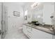 Modern bathroom with double vanity, glass shower, and marble tile at 1529 Corolla Ct, Reunion, FL 34747